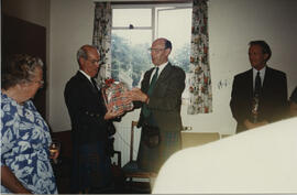 Photograph of a presentation to Dr Alastair MacFadyen by George Lawson