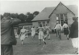 Photograph of a group dancing outside