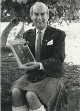 Photograph of Alastair MacFadyen with copy of Dance with your Soul